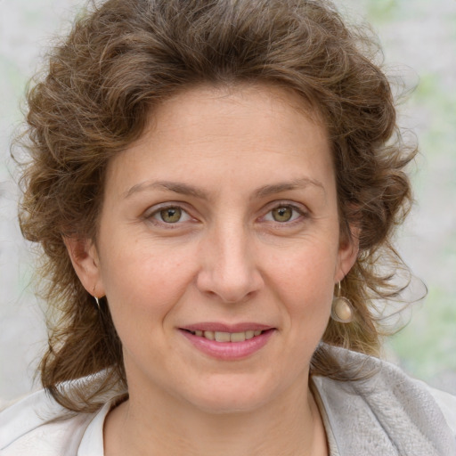 Joyful white adult female with medium  brown hair and blue eyes