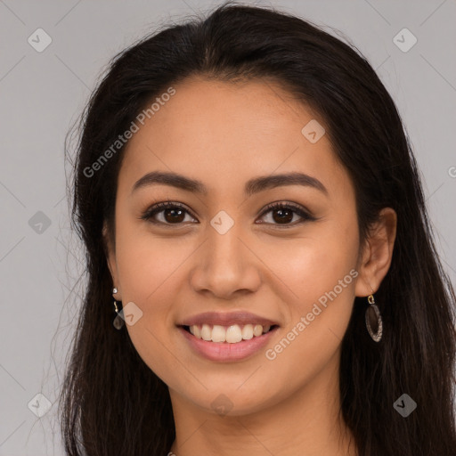 Joyful latino young-adult female with long  brown hair and brown eyes