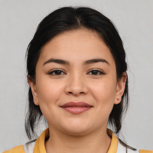 Joyful latino young-adult female with medium  brown hair and brown eyes