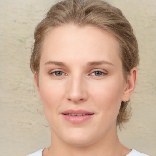 Joyful white young-adult female with medium  brown hair and blue eyes