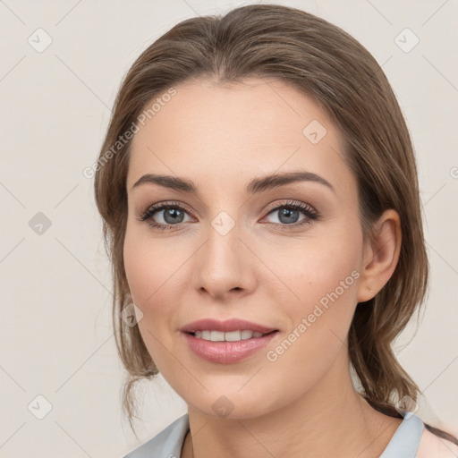 Joyful white young-adult female with medium  brown hair and grey eyes