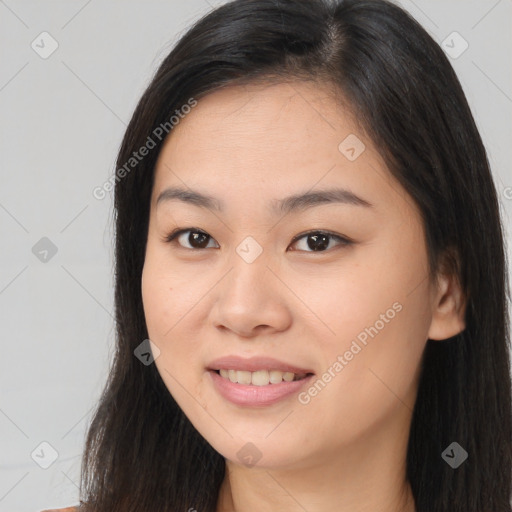 Joyful asian young-adult female with long  brown hair and brown eyes