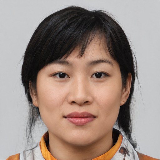 Joyful asian young-adult female with medium  brown hair and brown eyes
