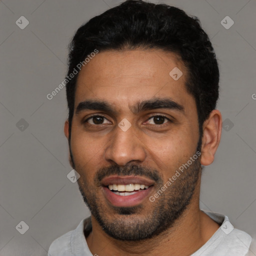 Joyful black young-adult male with short  black hair and brown eyes