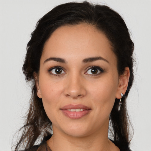 Joyful white young-adult female with long  brown hair and brown eyes