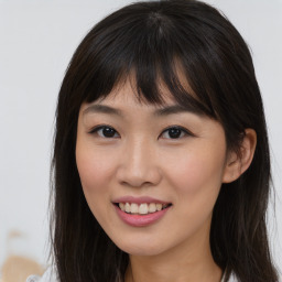 Joyful asian young-adult female with long  brown hair and brown eyes