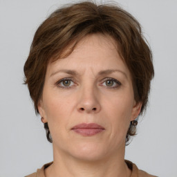 Joyful white adult female with short  brown hair and grey eyes