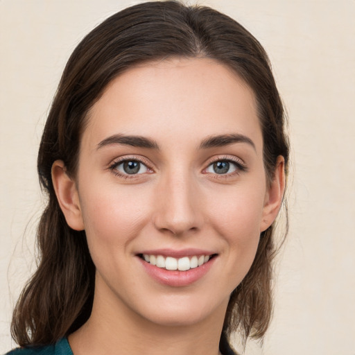 Joyful white young-adult female with medium  brown hair and brown eyes