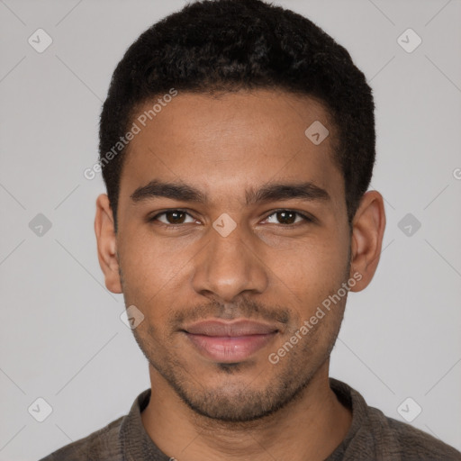 Joyful black young-adult male with short  black hair and brown eyes