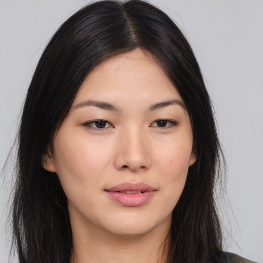 Joyful asian young-adult female with long  brown hair and brown eyes