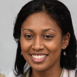 Joyful black young-adult female with medium  brown hair and brown eyes