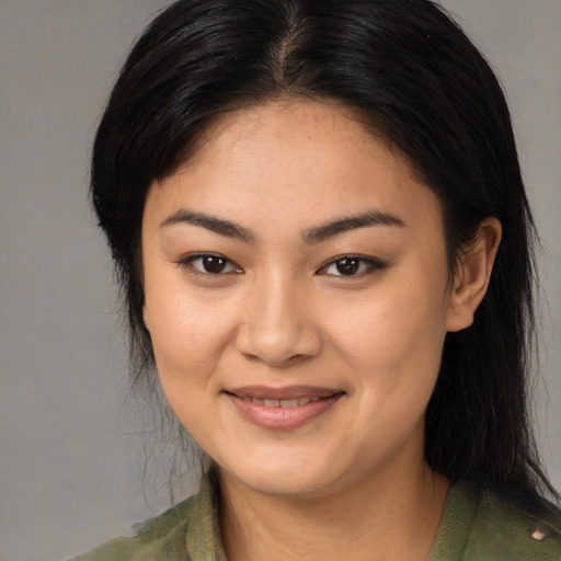 Joyful asian young-adult female with medium  brown hair and brown eyes