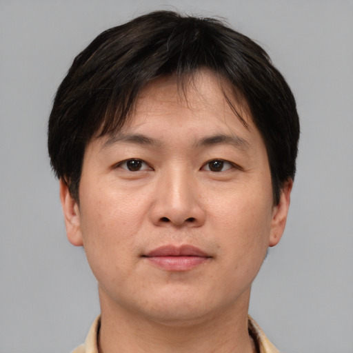 Neutral asian adult male with short  brown hair and brown eyes