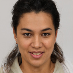 Joyful latino young-adult female with medium  brown hair and brown eyes