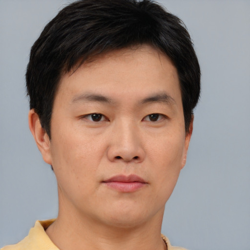 Neutral asian young-adult male with short  brown hair and brown eyes