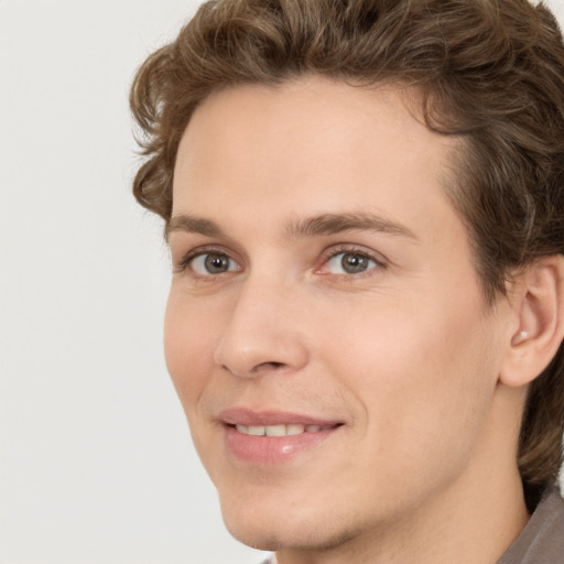 Joyful white young-adult male with medium  brown hair and brown eyes