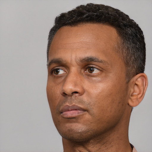 Neutral black adult male with short  black hair and brown eyes