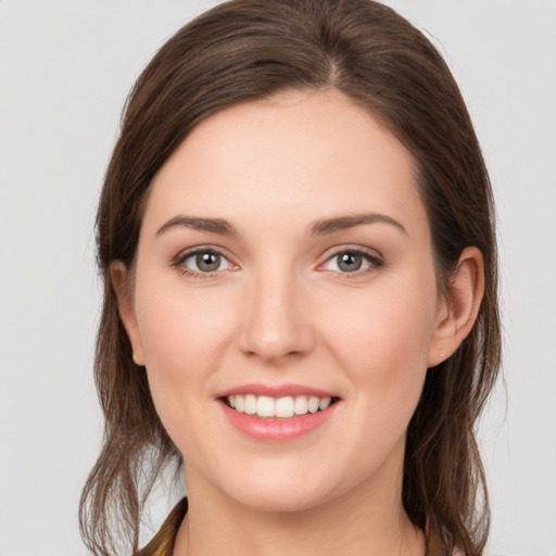 Joyful white young-adult female with long  brown hair and grey eyes