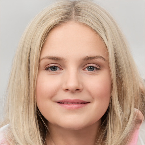 Joyful white child female with long  brown hair and blue eyes