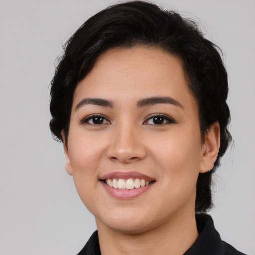 Joyful latino young-adult female with long  black hair and brown eyes