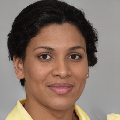 Joyful latino adult female with short  brown hair and brown eyes