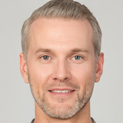 Joyful white adult male with short  brown hair and grey eyes