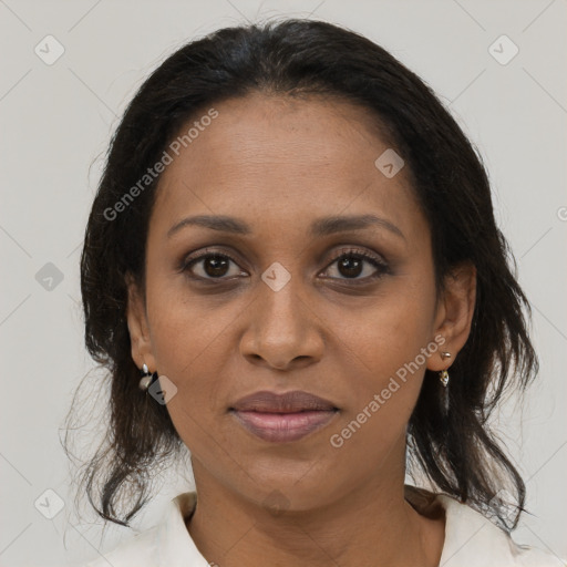 Joyful black adult female with medium  brown hair and brown eyes