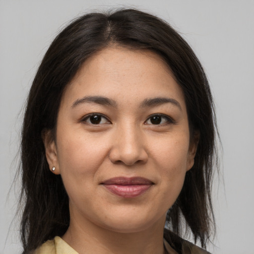 Joyful latino young-adult female with medium  brown hair and brown eyes