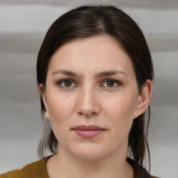 Joyful white young-adult female with medium  brown hair and grey eyes