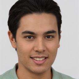 Joyful latino young-adult male with short  brown hair and brown eyes