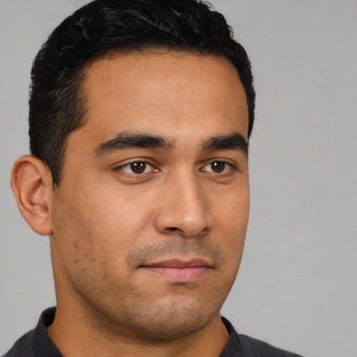 Neutral latino young-adult male with short  black hair and brown eyes