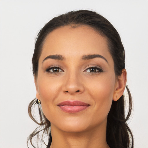 Joyful latino young-adult female with long  brown hair and brown eyes