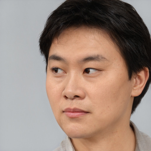 Neutral asian young-adult male with short  brown hair and brown eyes
