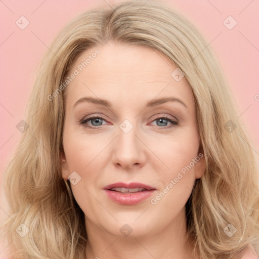 Joyful white young-adult female with long  brown hair and blue eyes