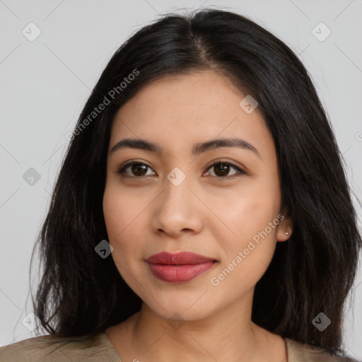 Joyful latino young-adult female with long  black hair and brown eyes