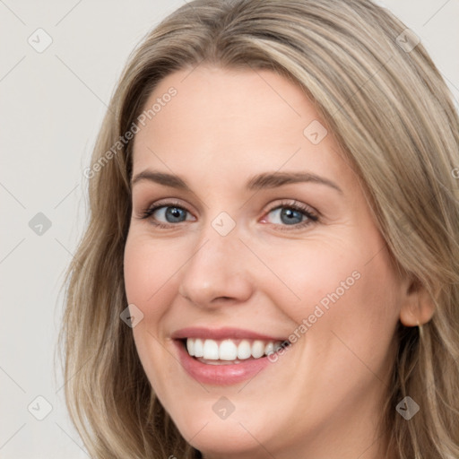 Joyful white young-adult female with long  brown hair and blue eyes