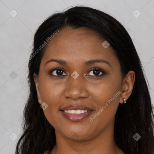 Joyful black young-adult female with long  brown hair and brown eyes