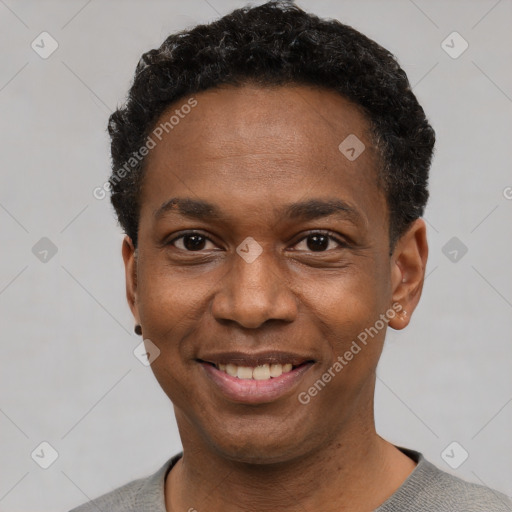 Joyful black young-adult male with short  black hair and brown eyes