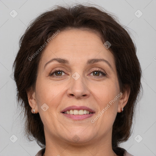 Joyful white adult female with medium  brown hair and brown eyes