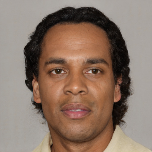 Neutral black adult male with short  black hair and brown eyes