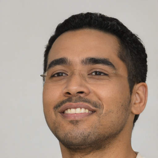 Joyful latino young-adult male with short  black hair and brown eyes