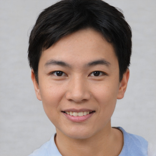 Joyful asian young-adult male with short  black hair and brown eyes