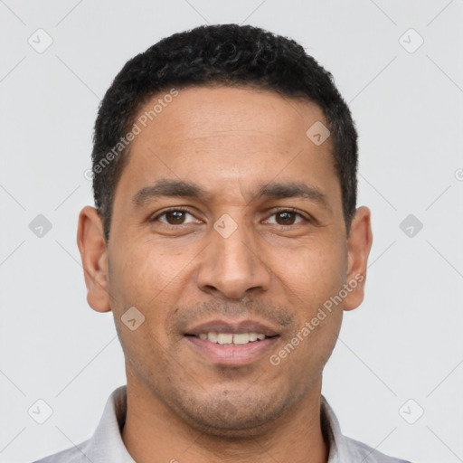 Joyful latino young-adult male with short  black hair and brown eyes