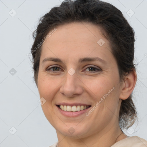 Joyful white adult female with medium  brown hair and brown eyes