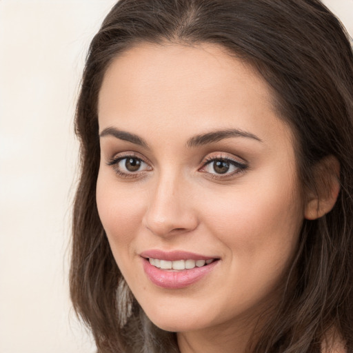 Joyful white young-adult female with long  brown hair and brown eyes