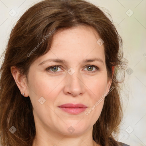 Joyful white adult female with medium  brown hair and green eyes