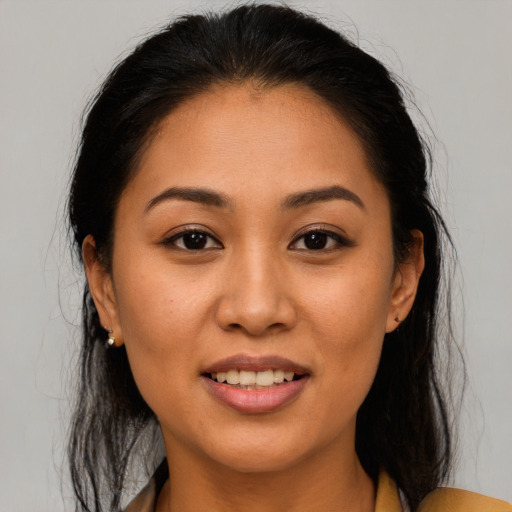 Joyful latino young-adult female with medium  brown hair and brown eyes
