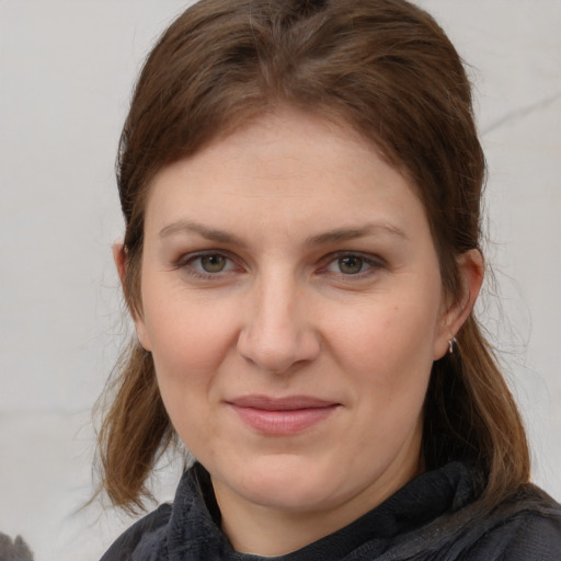 Joyful white young-adult female with medium  brown hair and grey eyes