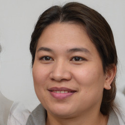 Joyful white young-adult female with medium  brown hair and brown eyes