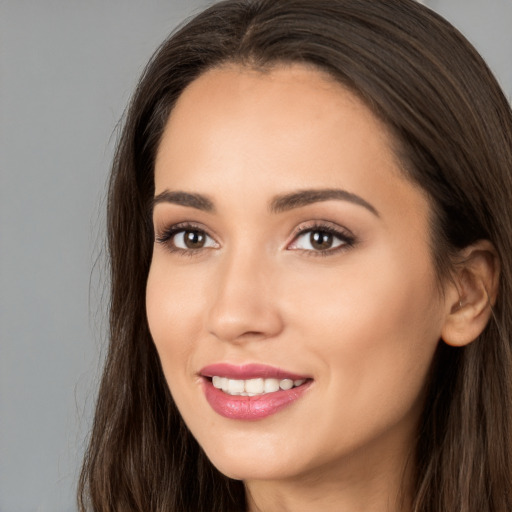 Joyful white young-adult female with long  brown hair and brown eyes